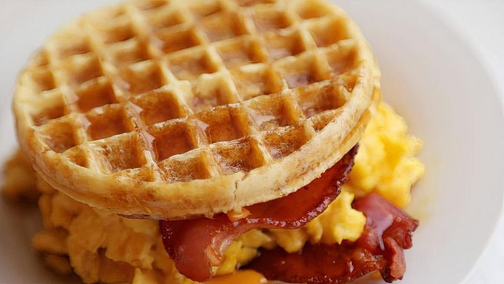 Bacon And Egg Waffle Sandwich · A fried egg with crispy bacon, melted cheddar cheese, and mayo sandwiched between two fluffy Belgian waffles.