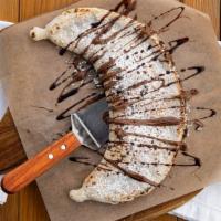 Nutellino Calzone · Dessert. Brick oven calzone filled with hazelnut chocolate, whipped.