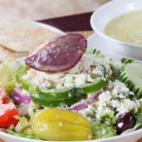 Soup And Salad Combo · Mini Greek salad with a cup of soup.