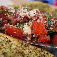 Bruschetta · Diced Roma tomato, fresh basil, feta cheese, and red onion tossed in balsamic vinegar and ex...