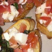 Tomato Brushctta · Toasted Italian bread with freshly diced tomato and mozzarella cheese with a touch of basil,...