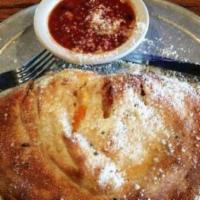 Cheese Calzone · Pizza dough stuffed with ricotta and mozzarella cheeses, oven baked, and served with a side ...