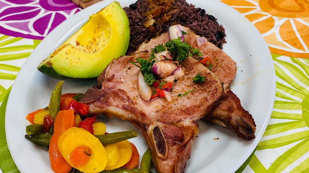 Chuleta Ahumada · Viene  con dos (2) acompañantes y opción de Arroz. | Smoked Pork Chop. Comes with your choice of any 2 sides and rice option.
