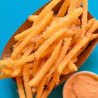 Parmesan Truffle Fries · Tossed in parmesan cheese and truffle oil and served with an optional side of chipotle aioli.