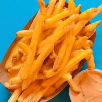 Queso Cheese Fries · Crispy fries topped with thick, creamy, and melty cheese.