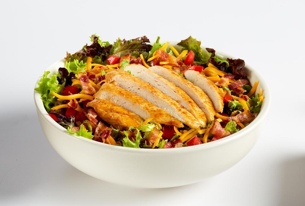 Grilled Chicken Club Salad · Grilled chicken breast served on seasonal greens with chopped Applewood smoked bacon, diced tomatoes, shredded cheddar cheese, and choice of dressing. 400 cal.