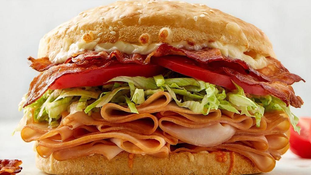 Turkey Bacon Club Sandwich · turkey | bacon | 3 cheeses | lettuce | tomato | lite mayo | signature sauce | sourdough bun.