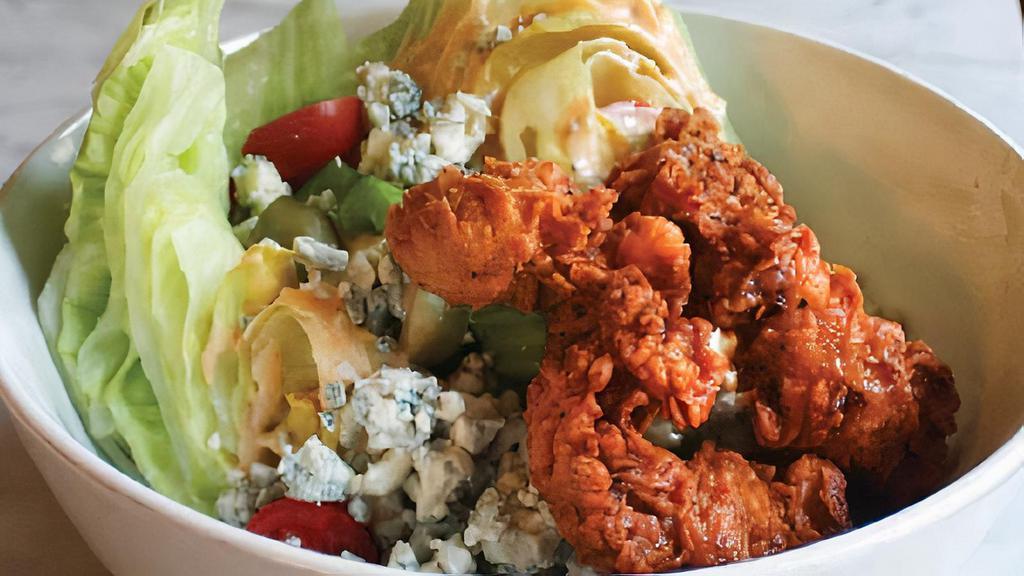 Huge Hot Chicken Wedge · Nashville hot chicken tenders, ‘Bama white sauce, chopped pickle, celery, blue cheese, olive, cherry tomato, ranch