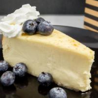 Plain New York Style Cheesecake · Sweet and creamy cheesecake, blueberries, whipped cream, graham cracker crust