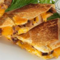 Quesadilla · Warm melted cheese and meat wrapped in a warm flour tortilla