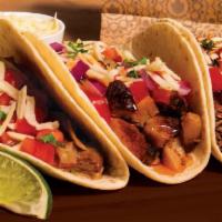 Taco · A soft flour tortilla or crunchy corn shell filled with your favorite meat and fresh toppings.