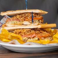 Sandwich De Pollo · Grilled chicken sandwich topped with onions, lettuce, tomatoes and julianne fries.