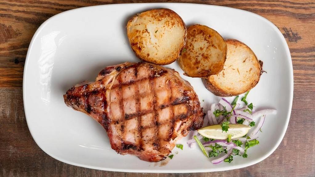 Chuleta De Puerco Ahumada · 2 Smoked Pork Chops with grilled onions