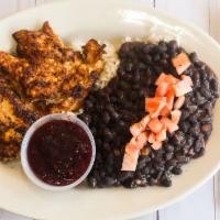 Jerk Chicken · Grilled jerk chicken breast served with black beans and rice, and raspberry sauce.