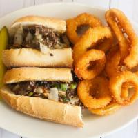 Philly Cheesesteak · Steak or chicken, sautéed bell peppers, onions, mushrooms, and mozzarella cheese. Served on ...