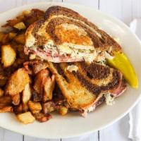 Reuben · Corned beef topped with Swiss cheese, Thousand Island, and sauerkraut. Served on rye bread.