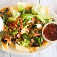 Classic Nachos · Grilled chicken, black beans, queso, lettuce, tomatoes, and jalapeño peppers. Served with so...