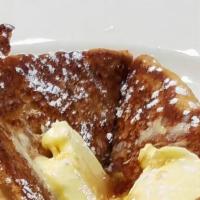 French Toast · Made with fresh baked Challah Bread served with butter and syrup
