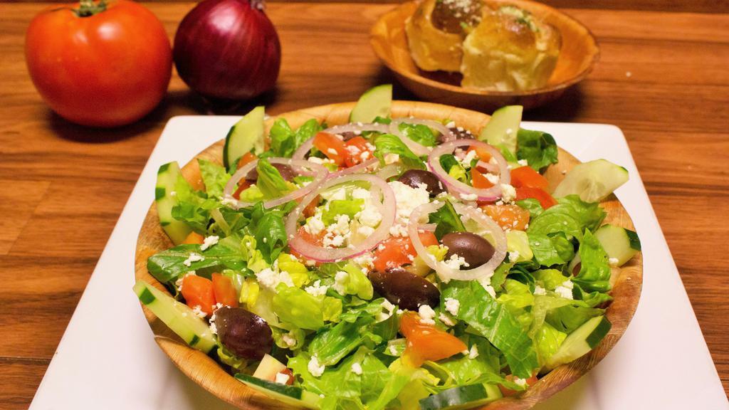 Greek Salad · Vegetarian. Romaine lettuce, tomatoes, cucumber, red onions, feta cheese and kalamata olives with Greek dressing. Plus 2 garlic rolls.