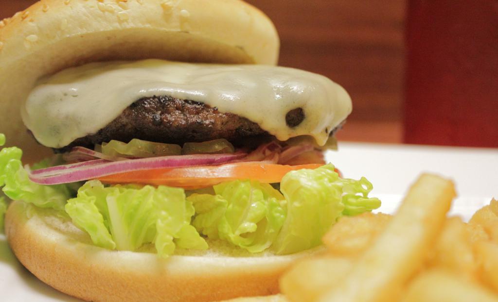 Cheeseburger · Half pound sirloin burger topped with mozzarella cheese. Served with lettuce, tomato, onions and pickles.
