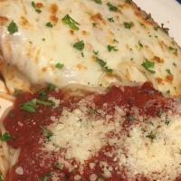 Chicken Parmigiana · Baked chicken breast topped with marinara sauce and mozzarella cheese, served with a side of...