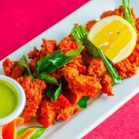 Chicken 65 · Spicy. Rice battered crispy boneless spiced chicken with ginger and curry leaves.