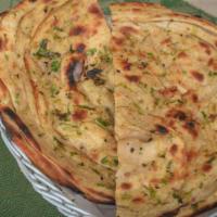 Onion Kulcha · Leavened flatbread topped with onion and spices baked in the tandoor.
