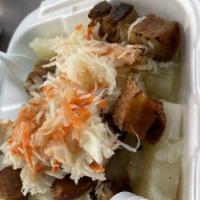 Vigoron · Boiled yuca, cabbage salad, and fried pork belly.