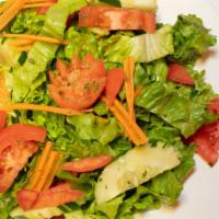 Tossed Salad · Vegan. Green leaf lettuce with carrots and cucumbers.