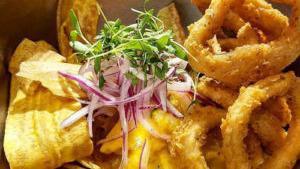 Bocas House Ceviche · Fish marinated in fresh yellow pepper tiger's milk, crunchy squid, fried plantain strips, an...