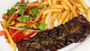 Skirt On The Grill · Skirt steak served with french fries, and vegetables.