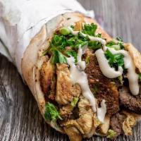 Mara Shawarma · Beef, chicken, falafel, and taboule, served in pita bread with Lettuce, Tomatoes, Onion, Gar...