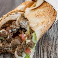 Beef Shawarma · Premium Beef marinated with Arabic Spices, roasted and server in pita bread with Lettuce, To...