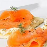Tostada De Salmon Ahumado · Grilled sourdough bread with smoked salmon, cream cheese, red onions, capers, and garnished ...