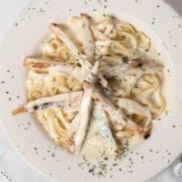 Fettuccine Alfredo · Our own white creamy sauce with parmesan, herbs, and spices.