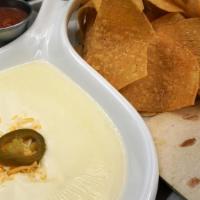 *Queso Dip* · White Queso made with Jalapenos.  Served with Flour Tortilla, Crunchy Corn Chips & House-mad...