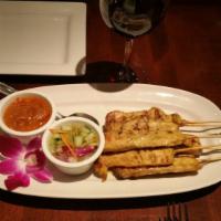 Chicken Satay · Chicken skewers (6) marinated in Thai spice, grilled and served with peanut sauce & cucumber...