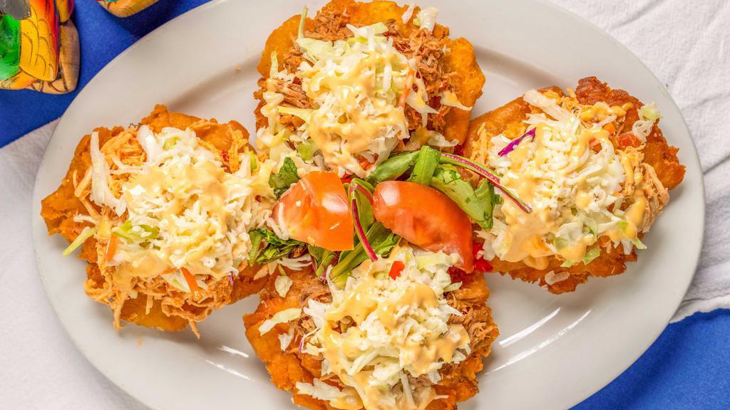 Playeros · Gluten free. Tostones topped with your choice of shredded beef, pork or chicken with coleslaw and pink sauce.
