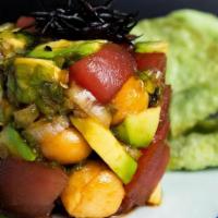 Tuna Poke Appetizer · Cubed tuna, avocado and macadamia nuts served with wonton chips