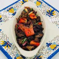 Lamb Tibs · Tender cubes of lamb marinated with our own signature sauce toasted with red onions, tomato,...