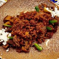 Tibs Firfir · Slowly roasted in rich berbere sauce with beef, red onion, fresh garlic, ginger in canola oi...