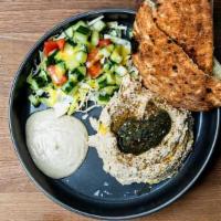 Hummus Bowl · Vegan. Israeli salad, tahini, schug, cabbage, pita.