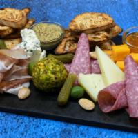 Charcuterie Board · Contains Nuts. Artisanal cheeses, selected meats, accouterments.