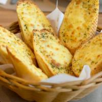 Cheesy Garlic Bread · Delicious warm bread topped with herb seasoning, fresh garlic, and cheese.