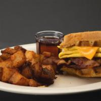 Bacon Egg & Cheese Waffle Sandwich · Made with a half waffle and an egg, crispy bacon and American cheese served with home fries ...