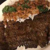 Carne Asada · grilled steak  served with white rice, red beans, sweet plantains and a side salad.
