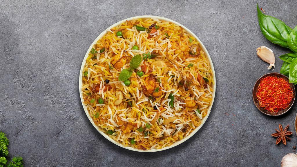 Vegetable Biryani · Spiced seasoned vegetables cooked with Indian spices and basmati rice. Served with house raita.