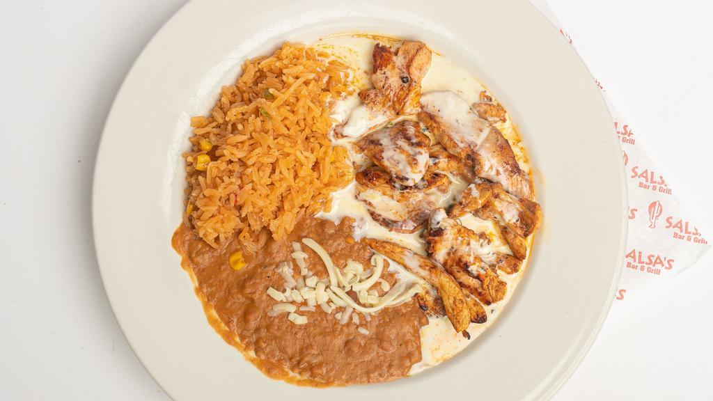 Pollo Con Crema · Tender marinated chicken strips topped with our specially prepared creamy sauce. Served with rice, beans, and tortillas.