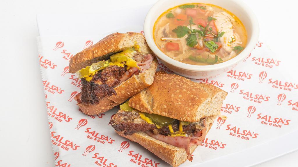 Cuban Sandwich · Cuban style sub stuffed with carnitas, ham, mustard and pickles. Served with a cup of chicken soup and a side of pickled jalapeños.
