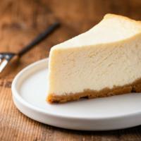 The Cheesecake · Freshly baked cheesecake with a side of guava sauce.